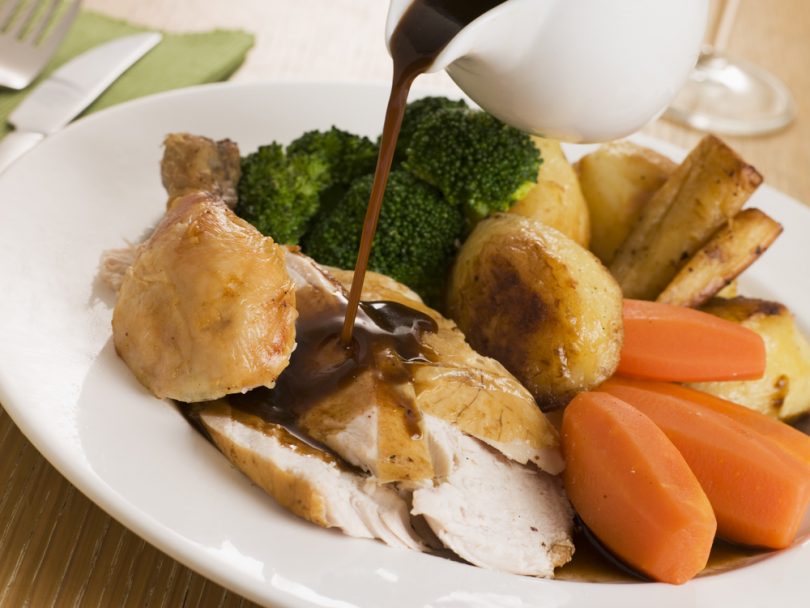 Gravy being Poured over a plate of Roast Chicken - local event food trend