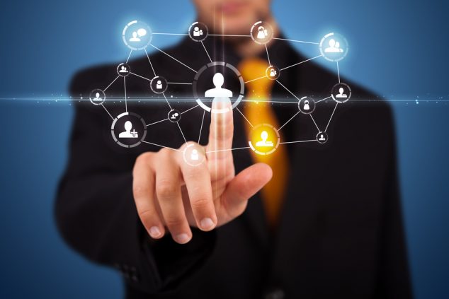Businessman pressing modern social buttons on a virtual background